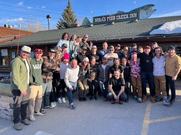 Group photo of Nomad Sports team outside Nora's Fish Creek Inn in Teton Village, Wyoming, celebrating camaraderie and team spirit.