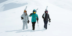 Three skiers carrying Kastle skis walk to the start of a run at Jackson Hole Mountain Resort in Teton Village Wyoming